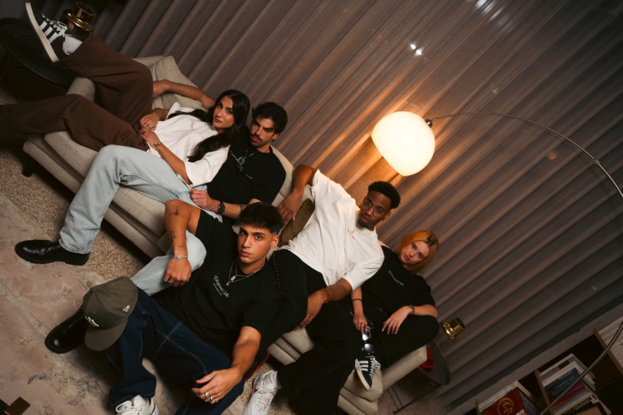 Dropout models showing rebel streetwear energy in oversized tees on a couch